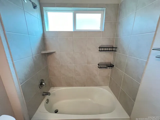 a white bath tub sitting in a bathroom
