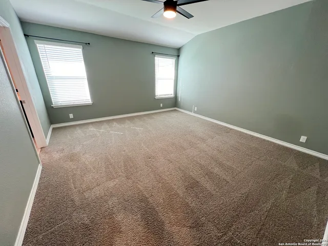 an empty room with windows and closet