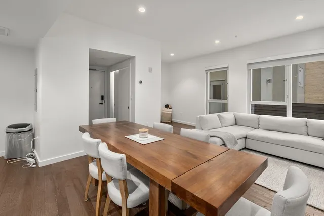a living room with furniture a wooden floor and sink