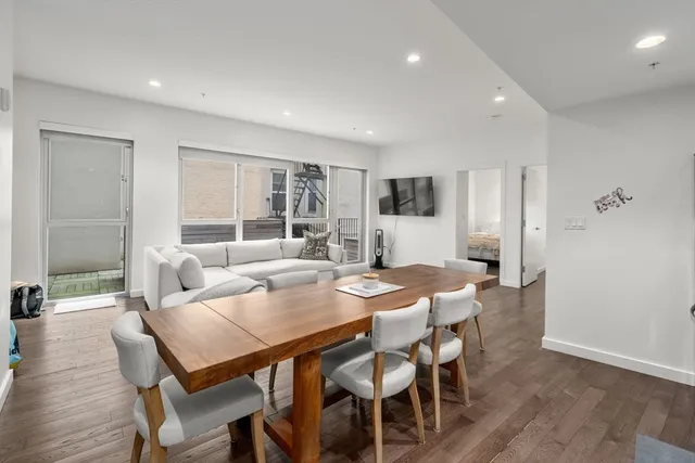 a view of a dining room with furniture and wooden floor