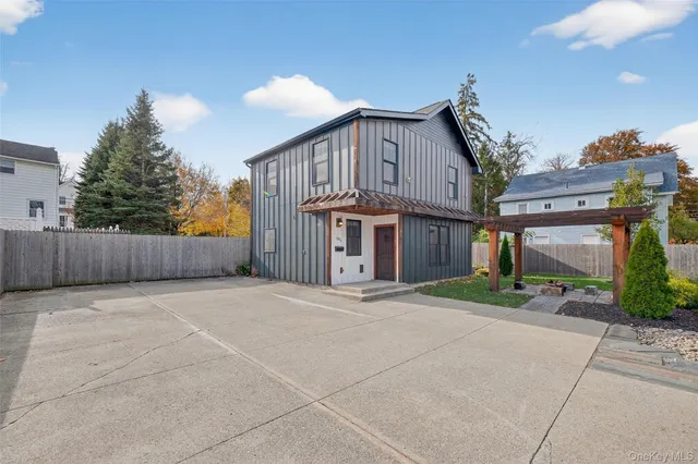 a front view of a house with a yard and a garage