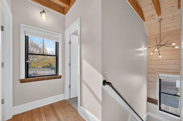 a view of an entryway with wooden floor