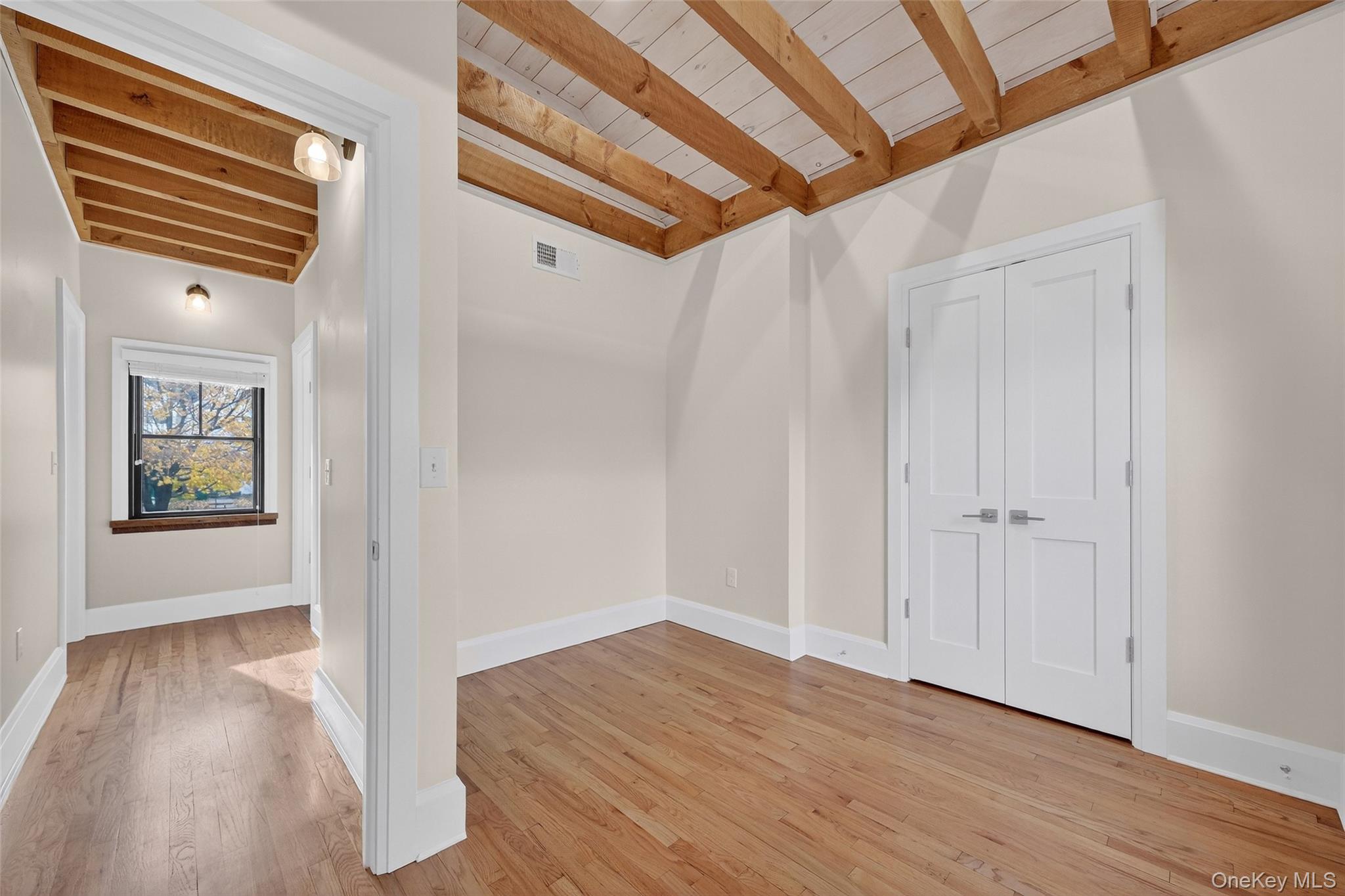 52 Ackerman Street, Unit 50 5 Beacon, NY 12508 - Photo 14 of 23 a view of a hallway with wooden floor and stairs