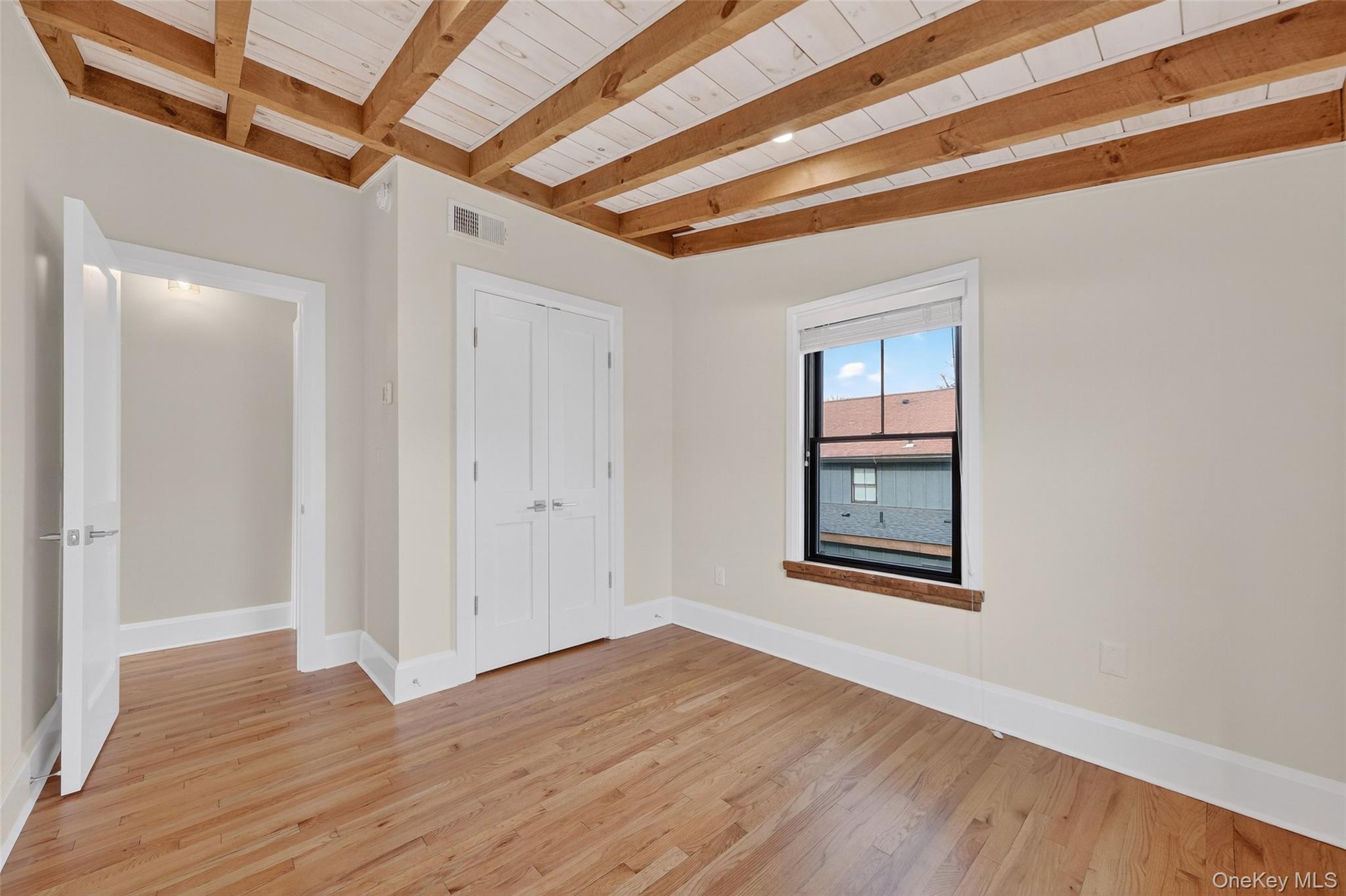 52 Ackerman Street, Unit 50 5 Beacon, NY 12508 - Photo 15 of 23 an empty room with wooden floor and windows