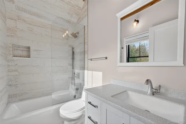a bathroom with a sink a toilet and bathtub