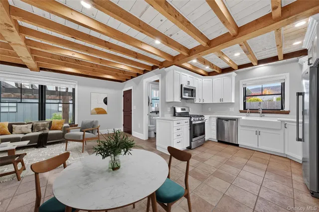 a kitchen with white cabinets and counter space