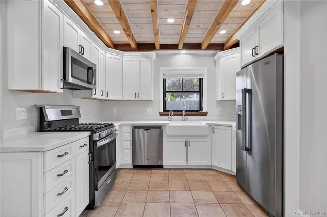 a kitchen with stainless steel appliances granite countertop a refrigerator and a stove top oven