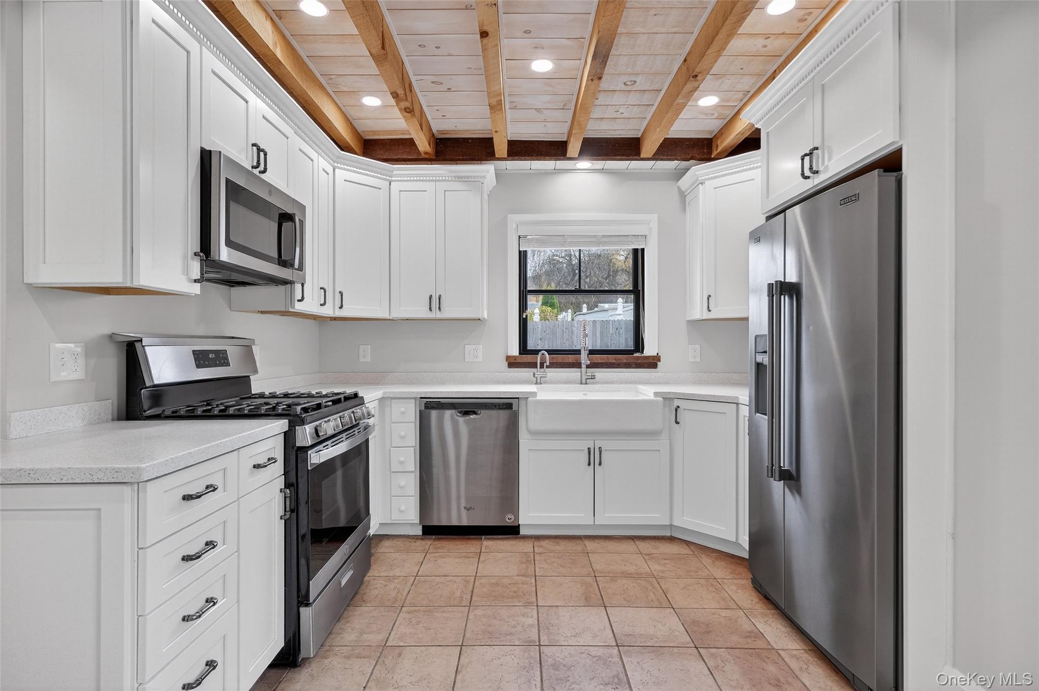 52 Ackerman Street, Unit 50 5 Beacon, NY 12508 - Photo 10 of 23 a kitchen with stainless steel appliances granite countertop a refrigerator and a stove top oven