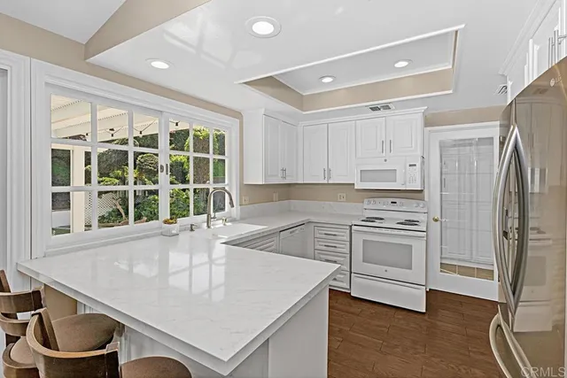 a kitchen with a stove a sink and a refrigerator