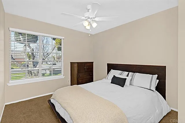 a bedroom with a large bed and a large window
