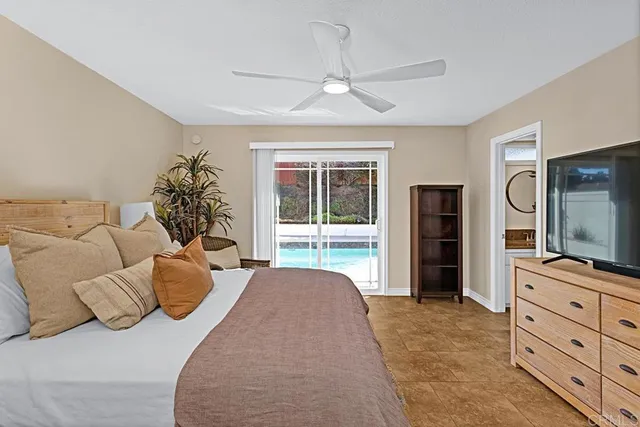 a bedroom with furniture and a flat screen tv