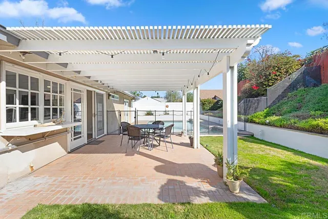 a view of a patio with a table chairs and backyard