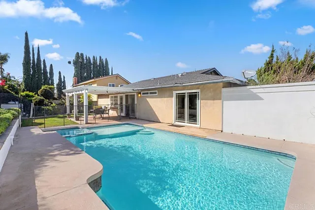 a view of a house with a yard and sitting area