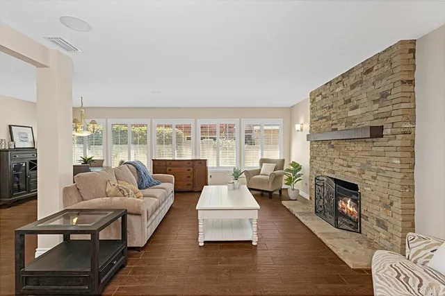 a living room with furniture wooden floor and a fireplace