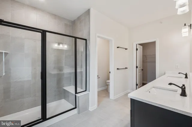 a bathroom with a sink double vanity granite tub and shower
