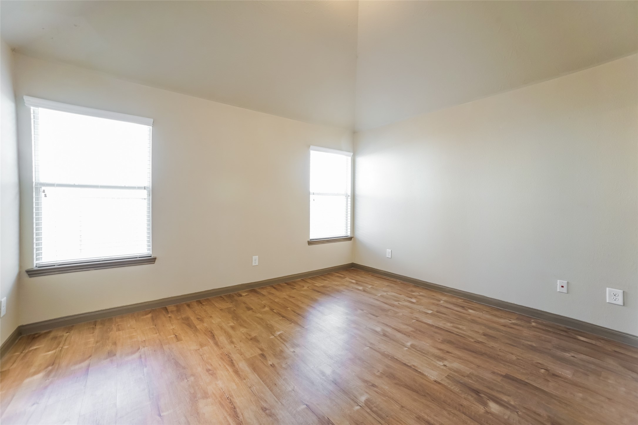 2450 Jonahs Way Houston, TX 77073 - Photo 6 of 13 an empty room with wooden floor and windows