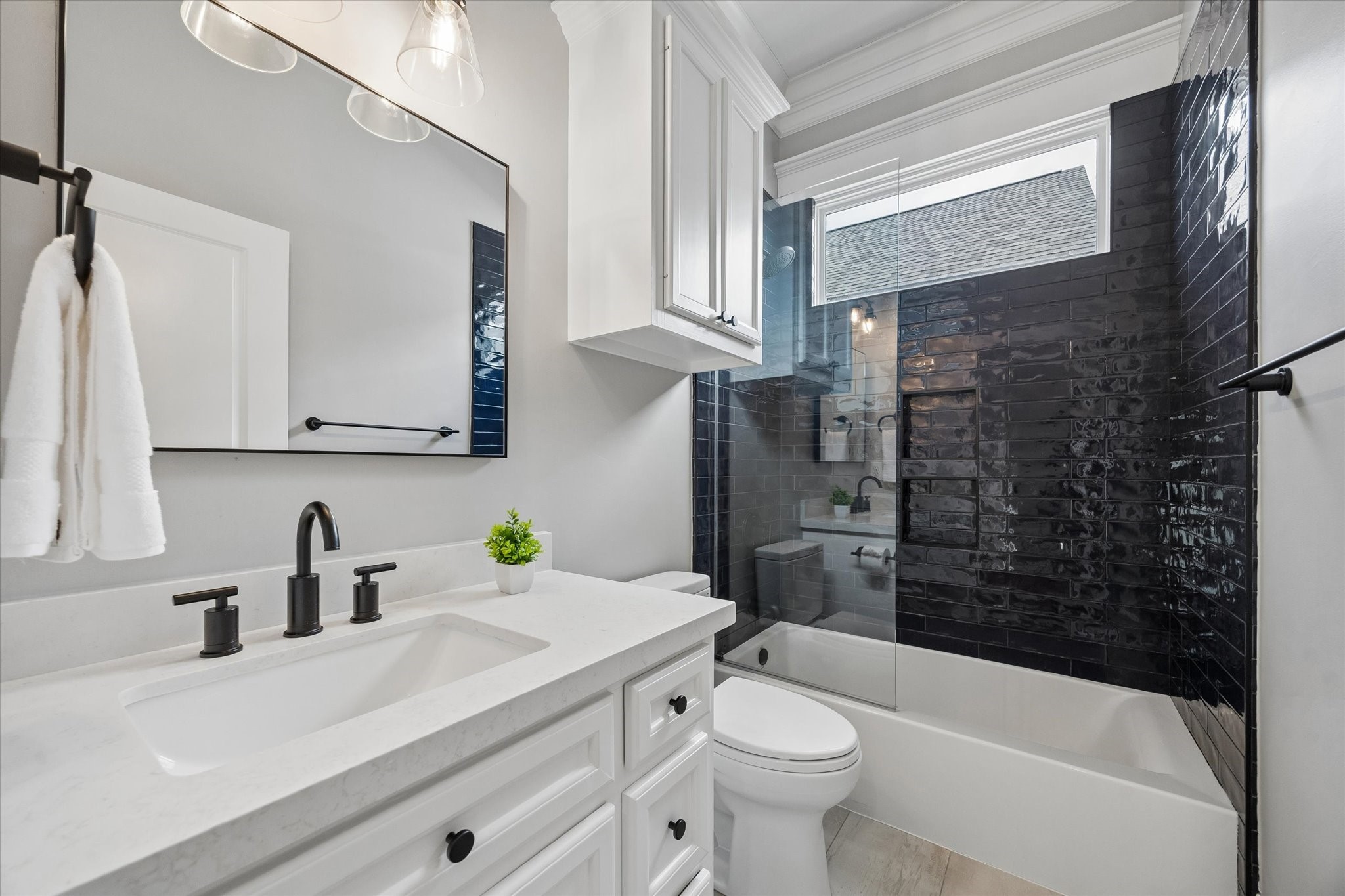 621 West 15th Street Houston, TX 77008 - Photo 26 of 37 The hall bath is conveniently located between the two secondary bedrooms featuring striking blue subway tile and quartz countertop.