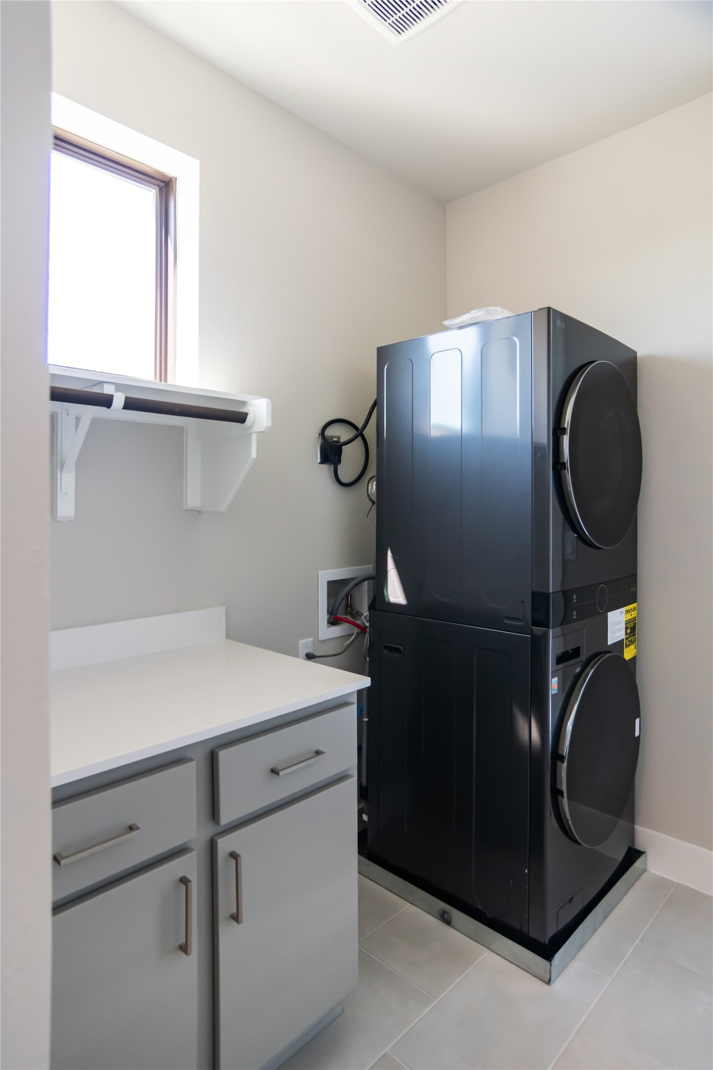 13309 Morris Road, Unit 11 Austin, TX 78729 - Photo 15 of 31 A dedicated laundry room provides optimal efficiency with a stacked washer/dryer unit and practical counter space.
