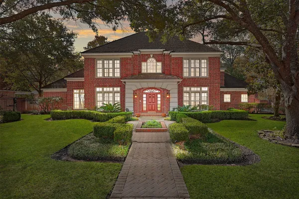 a front view of a house with garden and porch