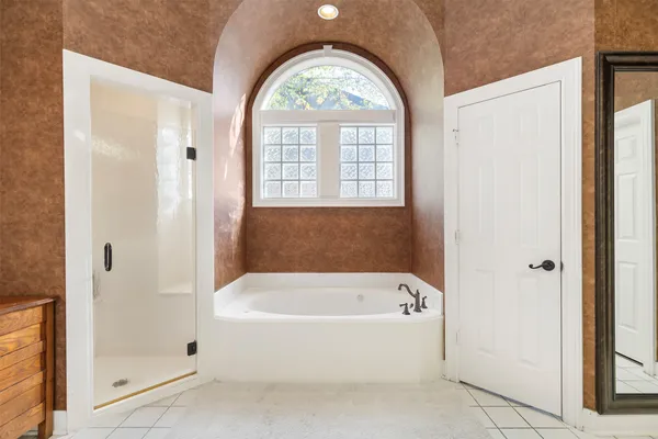 a white bath tub sitting next to a window