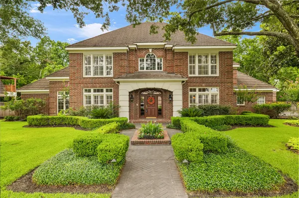 a front view of a house with garden and porch