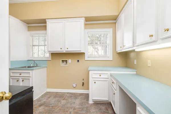 a kitchen with a sink cabinets and window