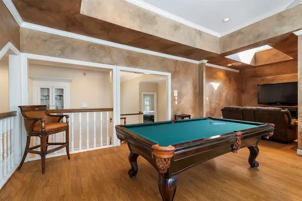 a room with pool table and windows