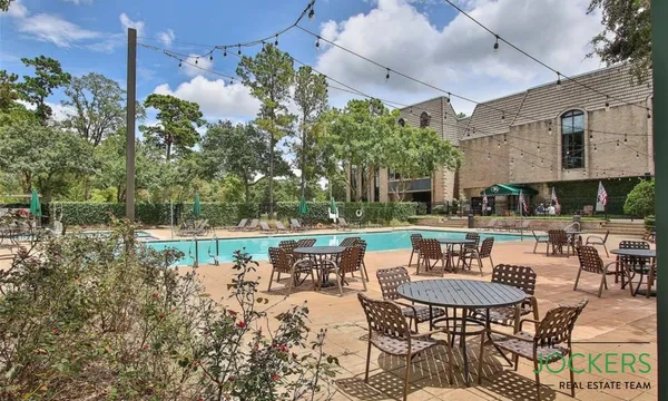 a front view of a house with swimming pool having outdoor seating