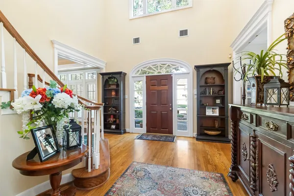 a living room with fireplace furniture and a potted plant