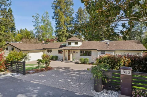 aerial view of a house with a yard and potted plants