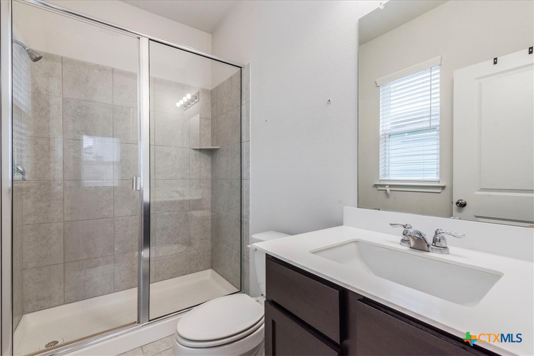 360 Spiny Lizard Lane San Marcos, TX 78666 - Photo 12 of 22 a bathroom with a sink toilet and shower