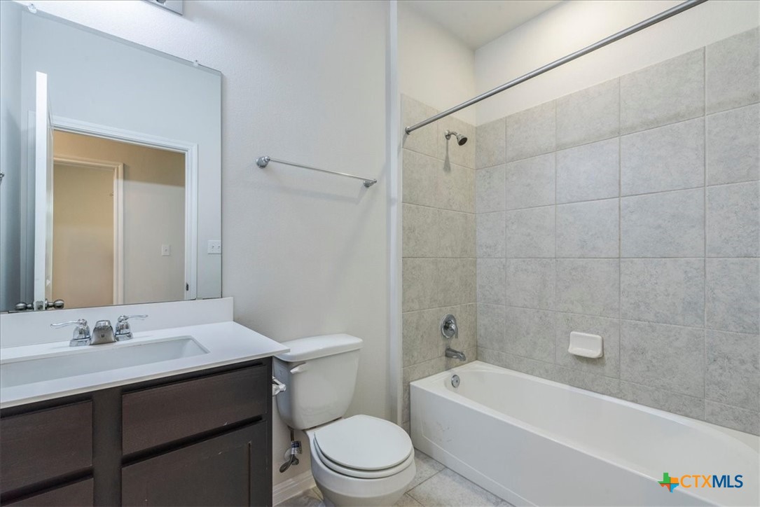 360 Spiny Lizard Lane San Marcos, TX 78666 - Photo 17 of 22 a bathroom with a bathtub shower sink mirror vanity and toilet