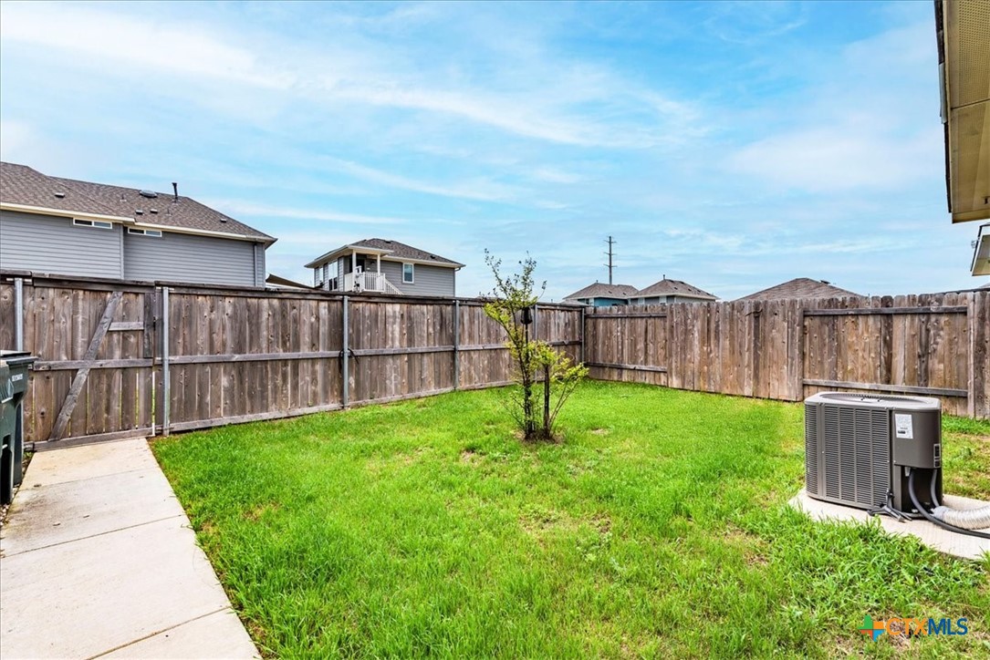 360 Spiny Lizard Lane San Marcos, TX 78666 - Photo 18 of 22 a view of a backyard with a garden and deck