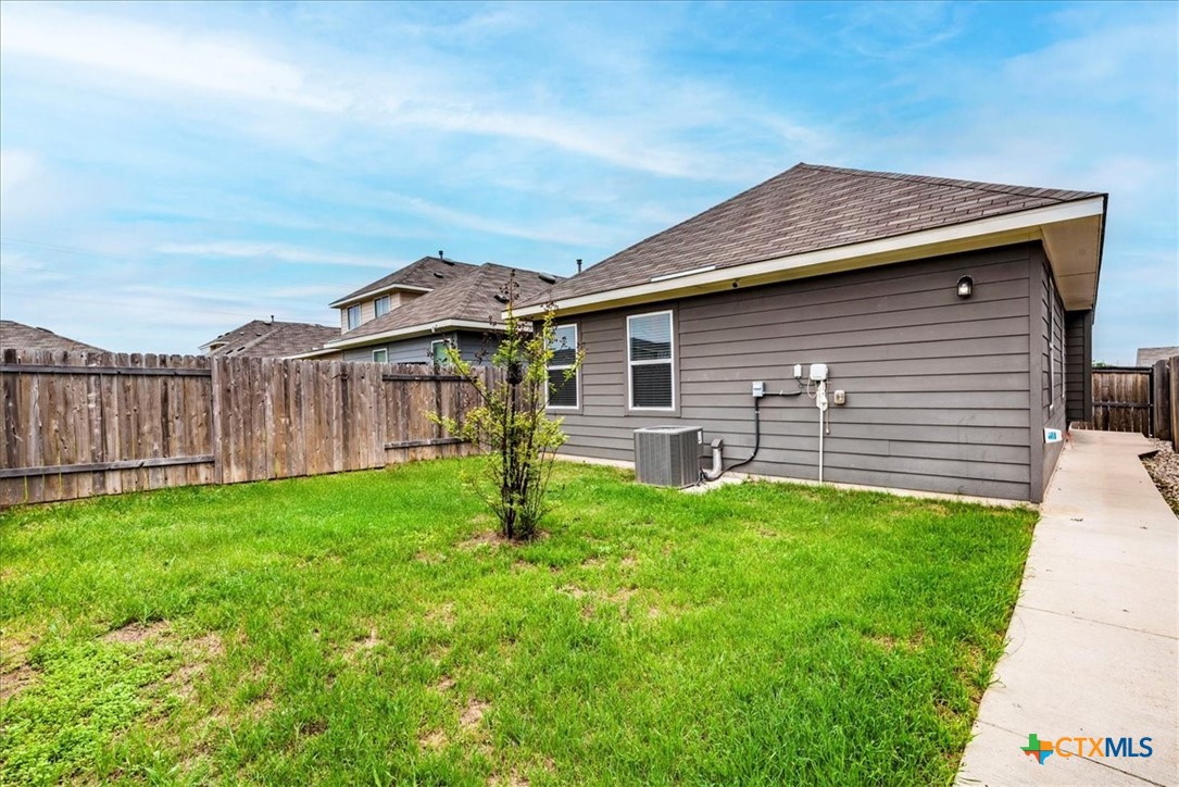360 Spiny Lizard Lane San Marcos, TX 78666 - Photo 19 of 22 a backyard of a house with table and chairs
