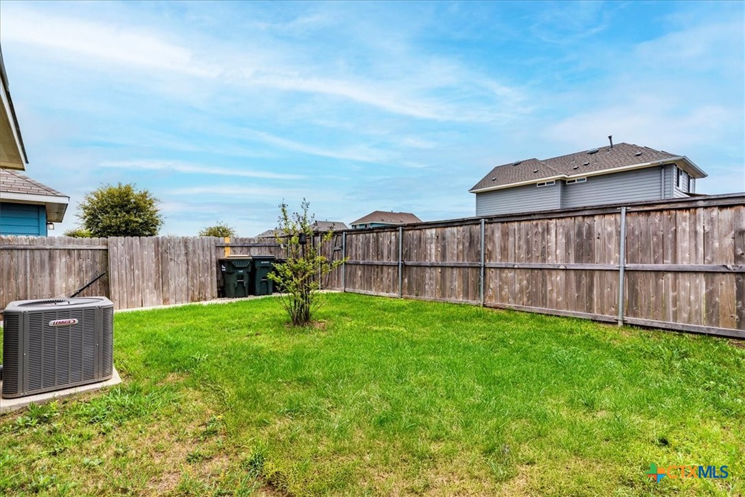 360 Spiny Lizard Lane San Marcos, TX 78666 - Photo 20 of 22 a view of a backyard with wooden fence