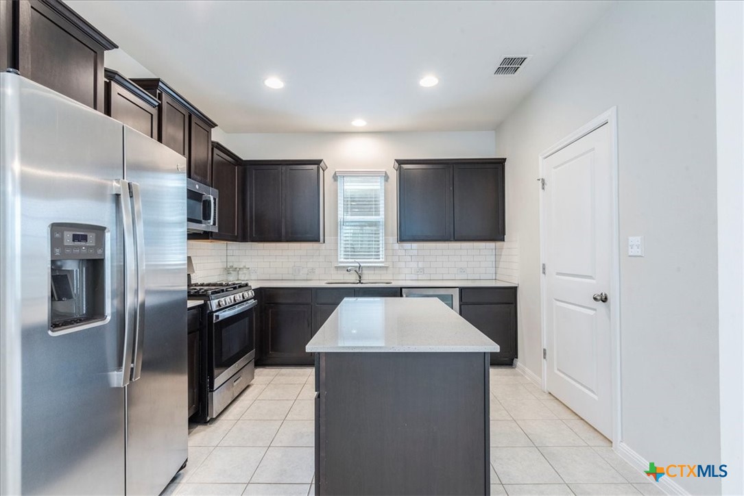 360 Spiny Lizard Lane San Marcos, TX 78666 - Photo 6 of 22 a large kitchen with stainless steel appliances granite countertop a refrigerator and a stove