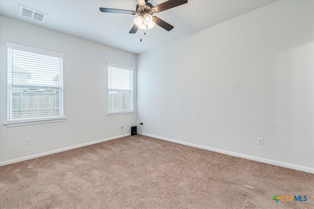 360 Spiny Lizard Lane San Marcos, TX 78666 - Photo 10 of 22 an empty room with windows and fan