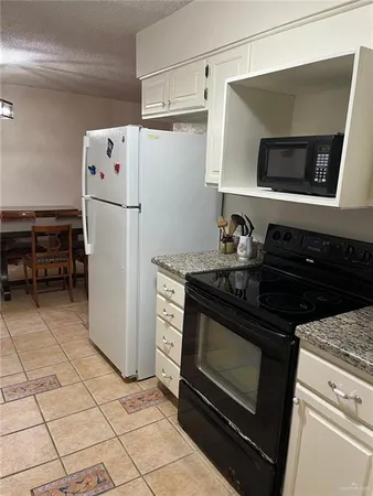 a kitchen with a stove and a refrigerator