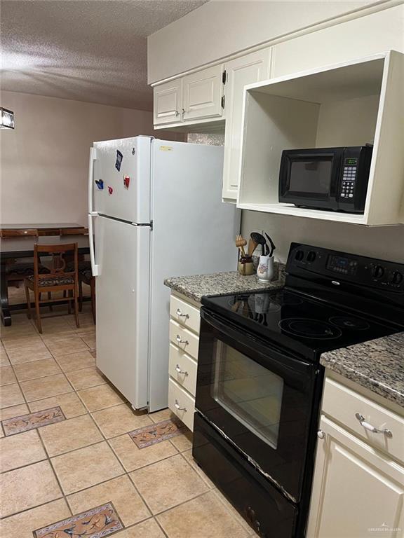 1216 Quail Avenue McAllen, TX 78504 - Photo 11 of 28 a kitchen with a stove and a refrigerator