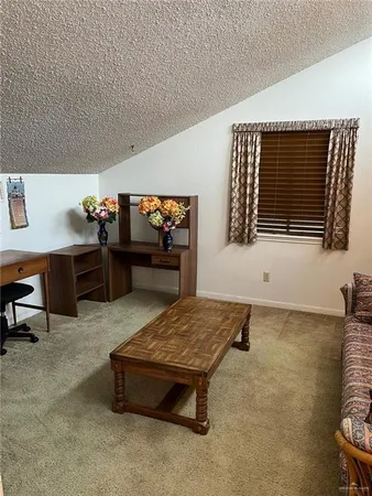 a living room with furniture pool table and a fireplace