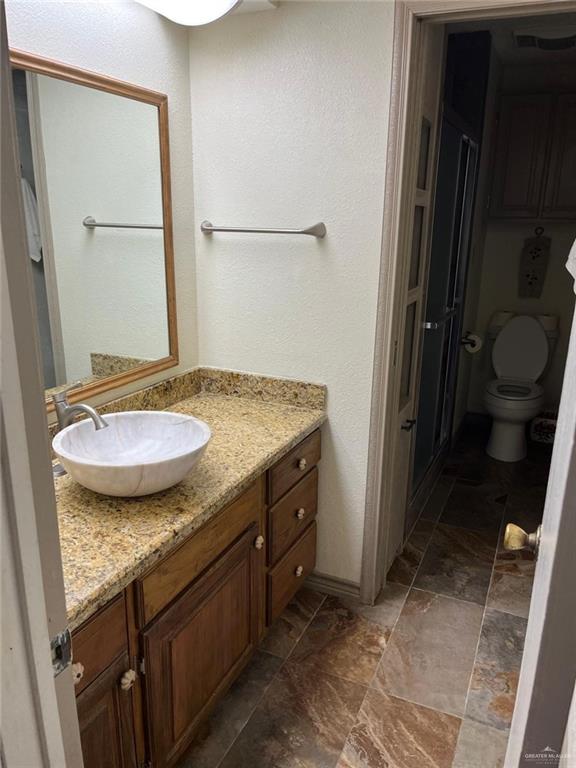 1216 Quail Avenue McAllen, TX 78504 - Photo 22 of 28 a bathroom with a granite countertop sink and a mirror