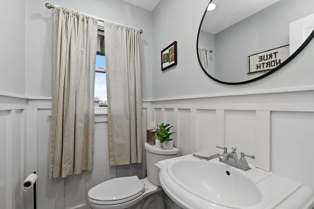 a view of a dining room with furniture a chandelier and wooden floor