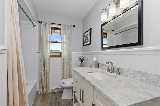 a kitchen with a sink and chairs