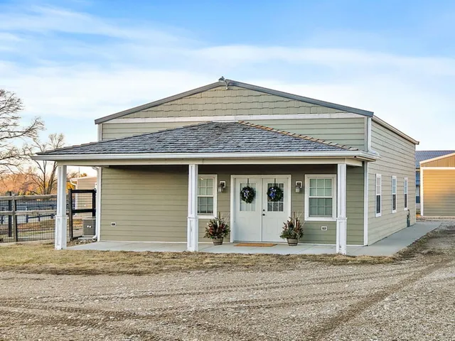 a living room with furniture and a refrigerator