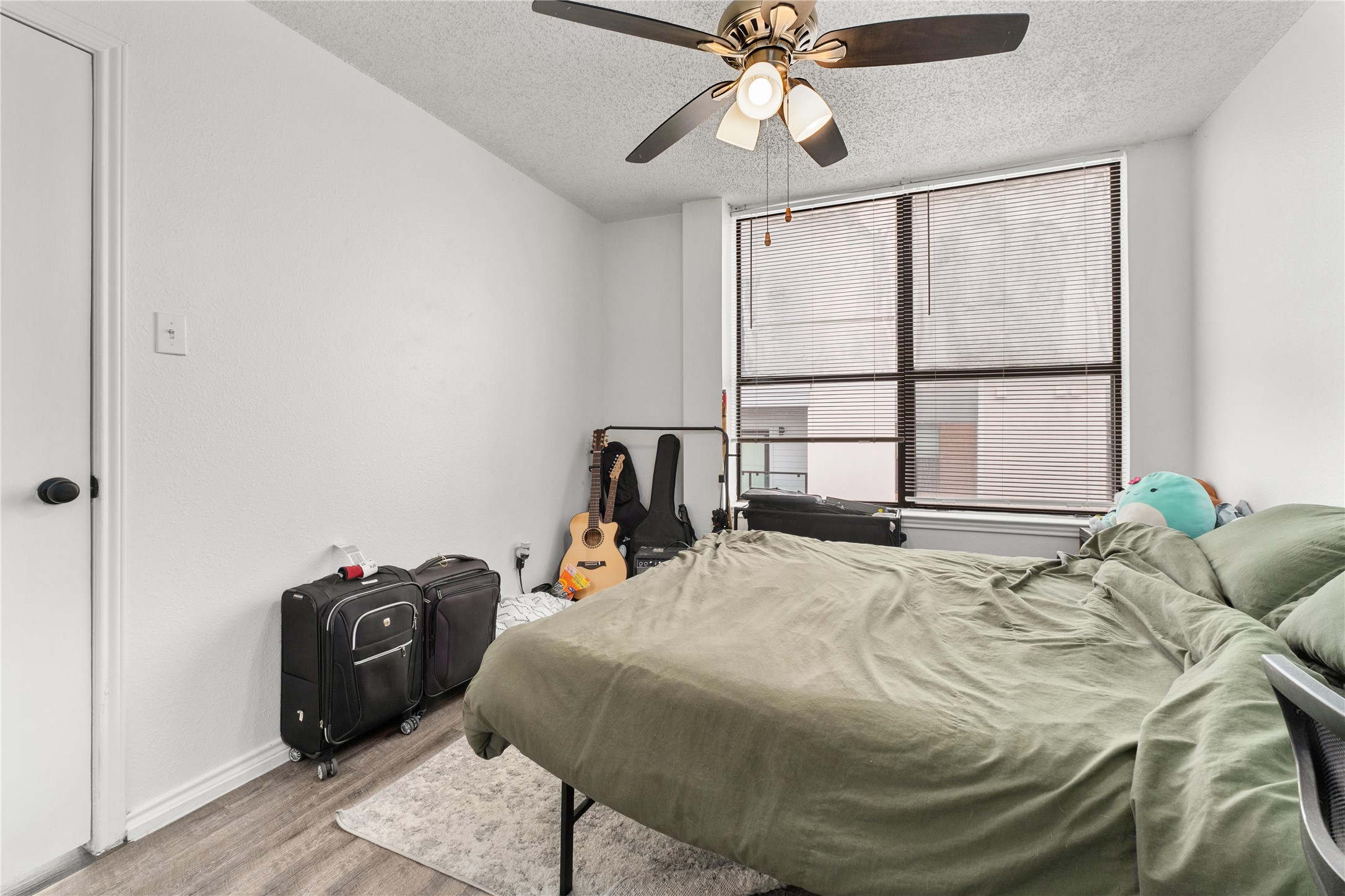 2409 Leon Street, Unit 307 Austin, TX 78705 - Photo 14 of 23 a bed sitting in a bedroom next to a window