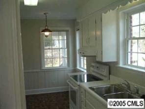 4501 Barwick Road Charlotte, NC 28211 - Photo 4 of 8 a kitchen with a sink a window and stainless steel appliances