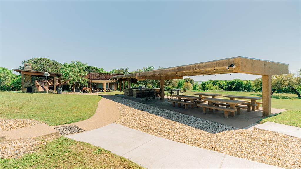 175 Tobacco Road Whitney, TX 76692 - Photo 29 of 35 View of community featuring a patio area and a yard