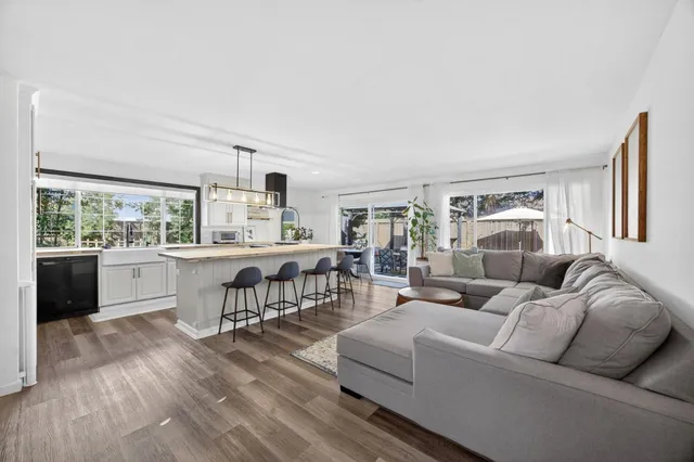 a view of a house with backyard outdoor seating and wooden floor