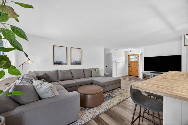 a view of a patio with table and chairs and wooden fence
