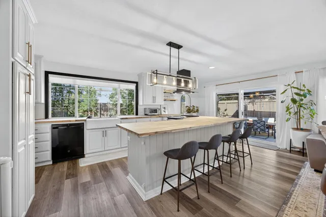 a view of a backyard with a garden and palm trees
